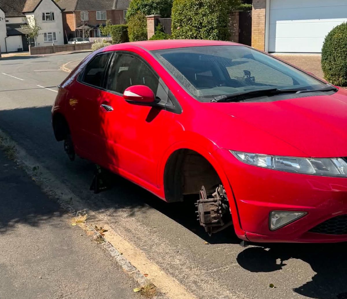Front brake work on a red Honda Civic